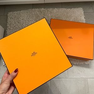 Two Hermes boxes with ribbon
